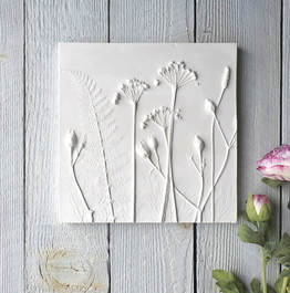 Plaster cast tile using wild garlic, Bracken & Ribwort plants to create the impression