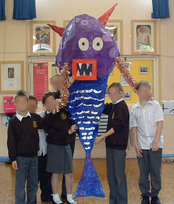 Sea monster made from a withy frame covered in tissue paper & painted