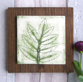 Green Ash leaf plaster cast tile on stained Ash