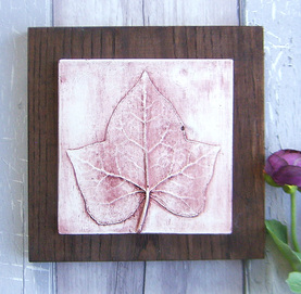 Red Ivy leaf plaster cast tile on stained Ash