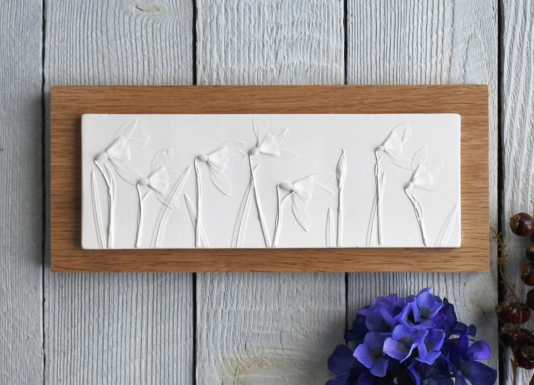 Long Snowdrops plaster cast tile on Oak